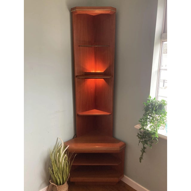 A striking vintage g plan corner unit dating from the 1970s–80s, crafted in richly toned teak veneer with softly rounded...