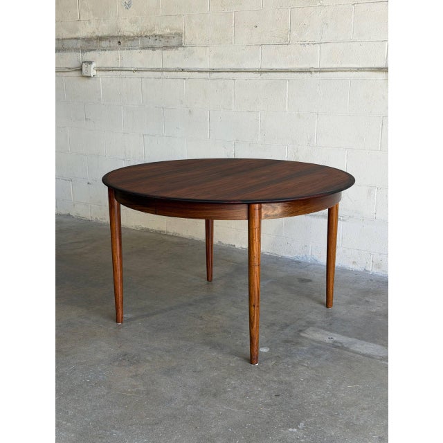 This versatile dining furniture pieces features a circular top that expands into a spacious elongated oval. The minimalist...