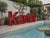 Large, distinctive vintage illuminated sign composed of red lacquered metal letters, each punctuated by exposed bulbs....