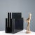Four-compartment magazine rack in black plastic. This piece is attributed to the mentioned designer/maker. It has no...