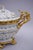 Louis XV style soup tureen in Paris porcelain on a white background with decoration of cornflowers and gilt flowers and...