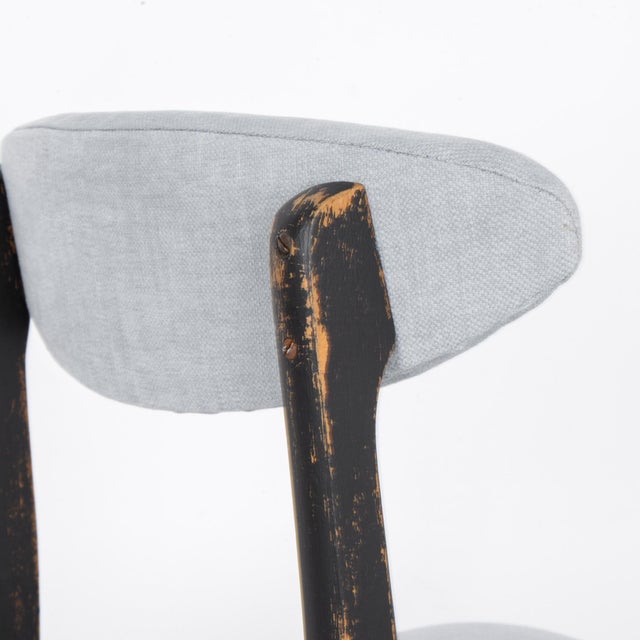 In the dynamic design landscape of 1970s Poland, this black-patinated wooden chair with an upholstered seat and back...