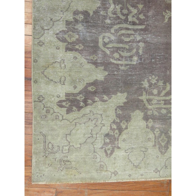 Room size early 20th century Shabby Chic antique gray field Oushak rug. We love the natural wear on this rug because it...