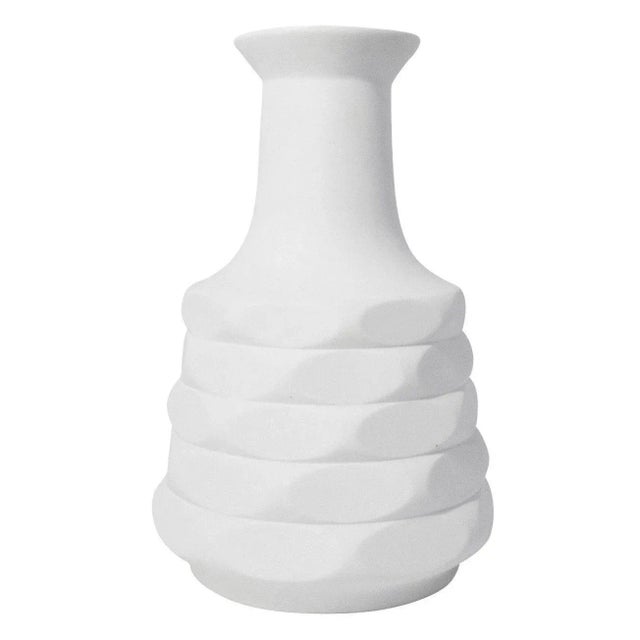 White Op Art bisque porcelain vase featuring a geometric bas relief design. Circa 1970s.
