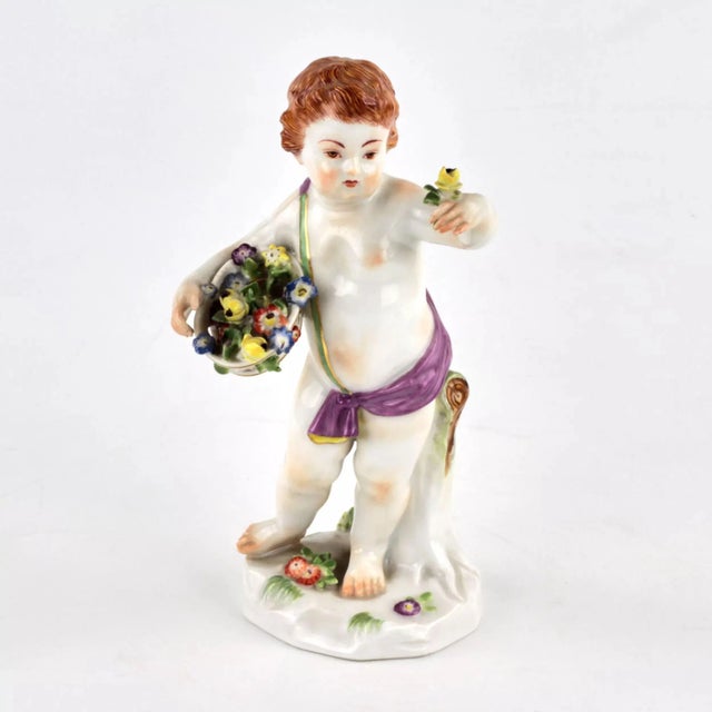 Porcelain figurine - allegory "Spring". Putti with a basket of spring flowers. Brand of the manufacturer Meissen.