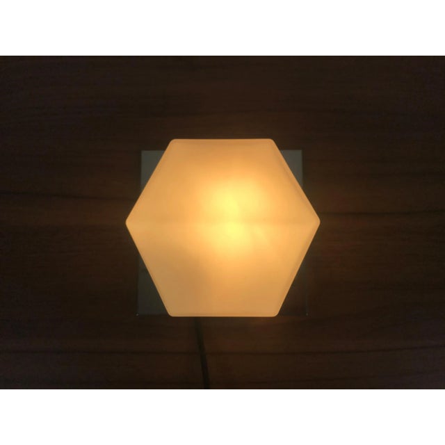 A beautiful Mid-Century Modern wall lamp by Glashütte Limburg made in Germany in the 1970s. It has a beautiful rectangle...
