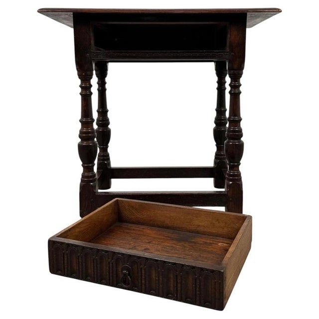 A handsome 19th-century English side table, finely crafted from oak and distinguished by its traditional turned legs,...