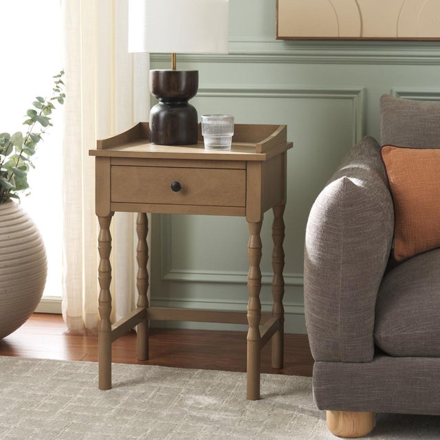 Discover the Astaroth Accent Table in a tranquil brown color, designed to elevate your living space with its understated...