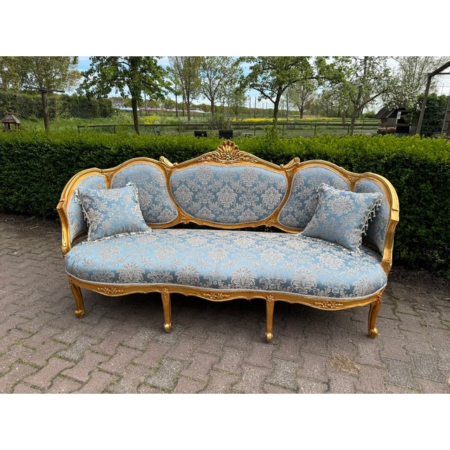 An elegant 1940 European French Louis XVI-style sofa set, fully handmade from solid beech wood and consisting of one...