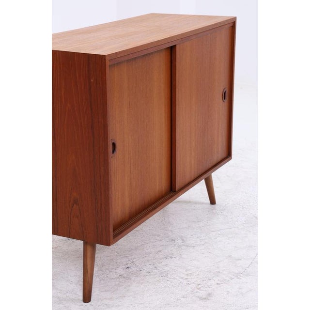 Vintage chest of drawers from Musterring with beautiful teak grain. The understated design and tapered legs give the piece...