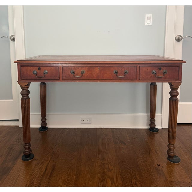 Elegant vintage Regency-style writing desk crafted in richly figured wood, believed to be yew, surrounding an inset...