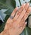 A 3.65-carat emerald-cut lab grown diamond takes center stage in this solid platinum estate ring, surrounded by sixty-four...