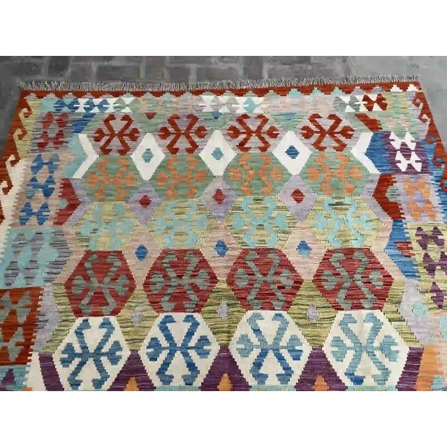Islamic Vibrant Hand-Woven Kilim Rug With Intricate Geometric Patterns For Sale - Image 3 of 8