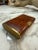 Elegant Art Deco cigarette case features a beautifully figured burl wood body complemented by brushed brass accents. The...
