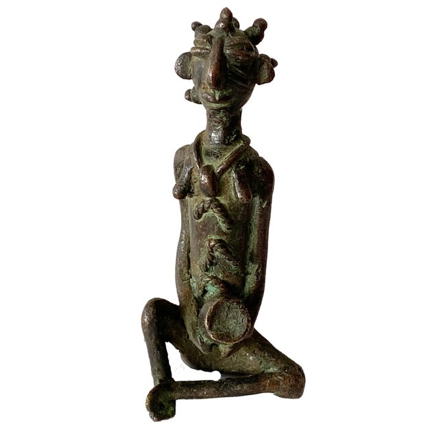 This stunning Benin bronze figurine depicts a seated female holding a jar, measuring approximately 6 inches in height by...