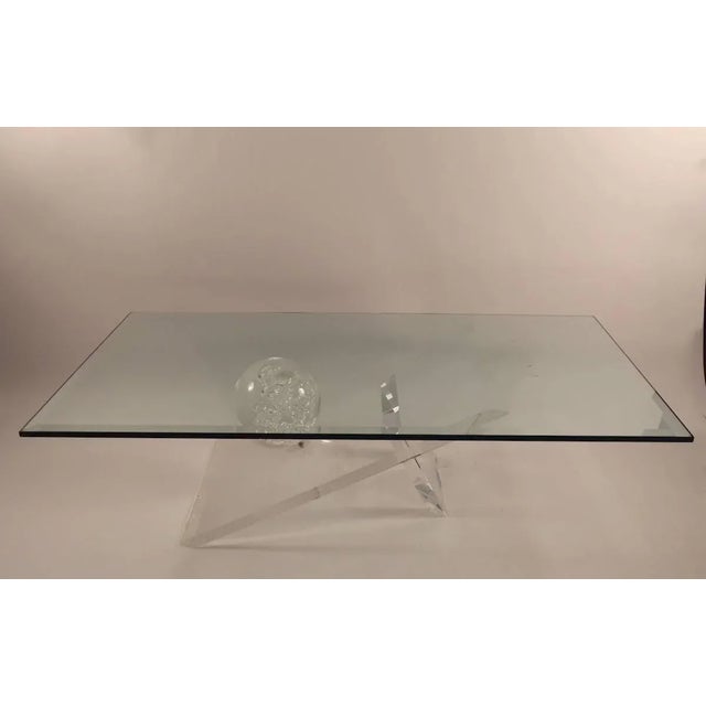 Lucite base with large ball form, supports thick bevelled glass. Measures: top (1" thick x 1.75" bevel), base 28"- L x...