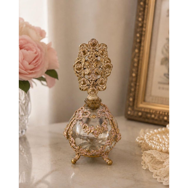 Vintage French style glass perfume bottle adorned with elaborate gilt metal floral filigree and an exceptional openwork...
