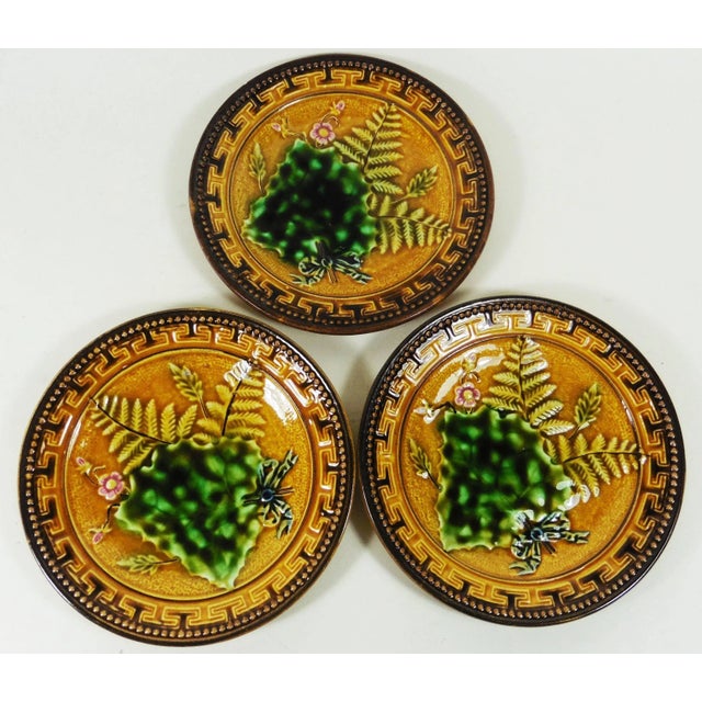 Small Majolica plate with leaves, fern, pink flowers signed Utzschneider et compagnie Sarreguemines.