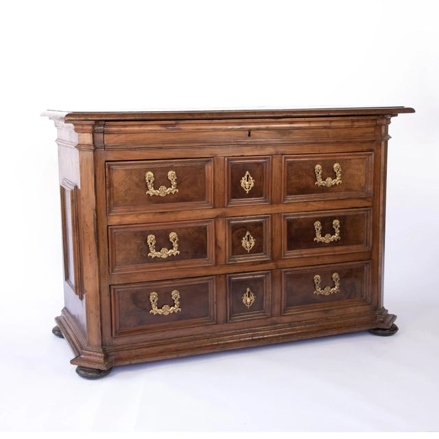 Italian walnut commode, likely Lomardy, circa 1750; with raised walnut moulded panels with burl inset on front and sides,...