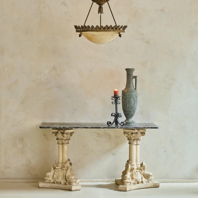 A French concrete and marble console from the 1940s, where neoclassical language is reinterpreted through weight, texture,...