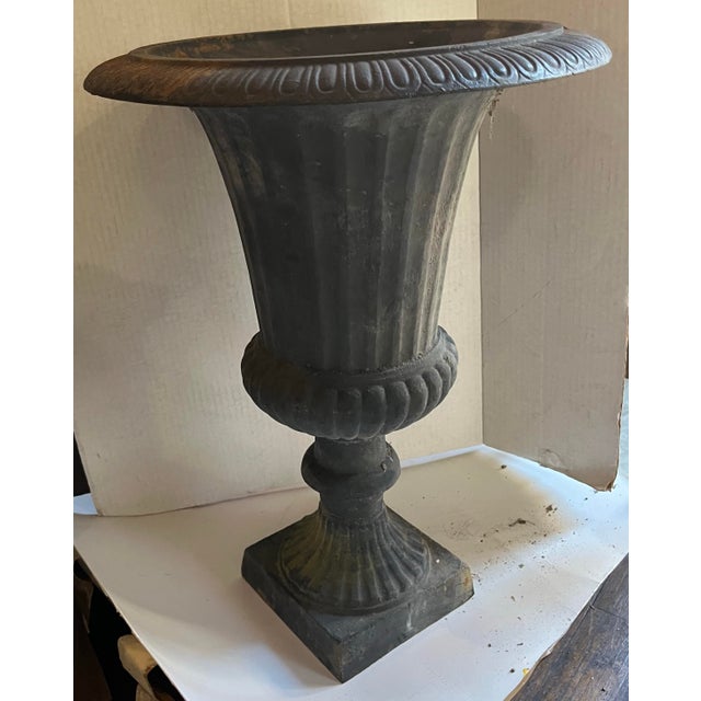 A great find. Cast iron classic design garden urn with fluted stem and beautiful scalloped top.