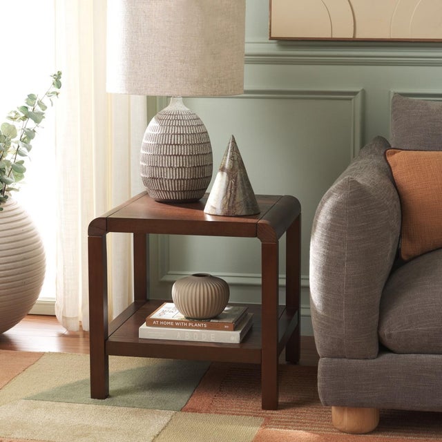 Enhance your living space with the Omara 1 Shelf Side Table in Walnut. Crafted with wood, this piece showcases a rich...