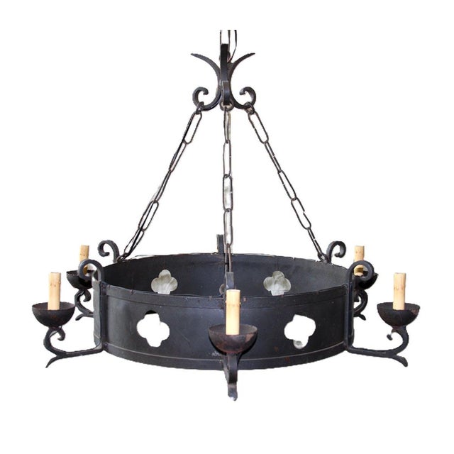 A French iron ring shaped six-light chandelier. This dark colored ring-shaped chandelier is connected at the top by three...