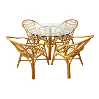 Vintage Rattan Dining Set With Four Arm Chairs and Glass Top For Sale