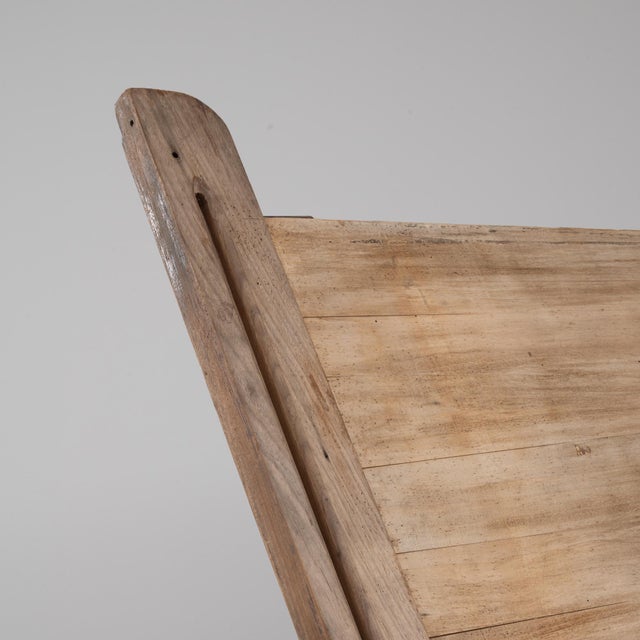 A 20th Century Belgian industrial drawing table featuring a solid wooden top supported by an adjustable iron base. The...