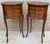 Elegant pair of French bedside tables in the Louis XV style, featuring oval tops decorated with delicate floral marquetry...