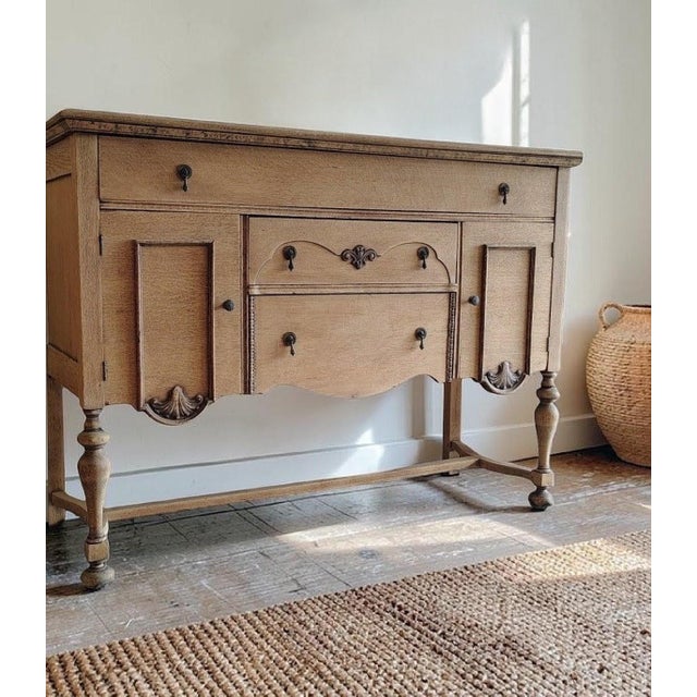 Dimensions: 54"L x 39"H x 19"D Tiger Oak quarter sawn solid wood sideboard / buffet with scalloped apron turned legs,...