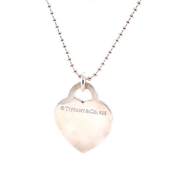 A rare Tiffany & Co. Please Return to Tiffany Heart Tag necklace crafted in sterling silver, featuring the iconic heart...