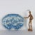 High fire majolica shaving basin in monochrome shades of blue. Oval in shape with expanded rim. Decoration depicting a...
