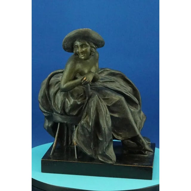 Object description: Sculpture depicting a seated lady in 18th-century dress, made of stoneware or soft terracotta, clay...