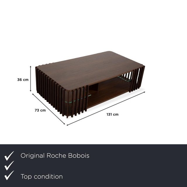 This elegant Roche Bobois Palis coffee table combines modern architecture with warm, natural elements. The dark brown...