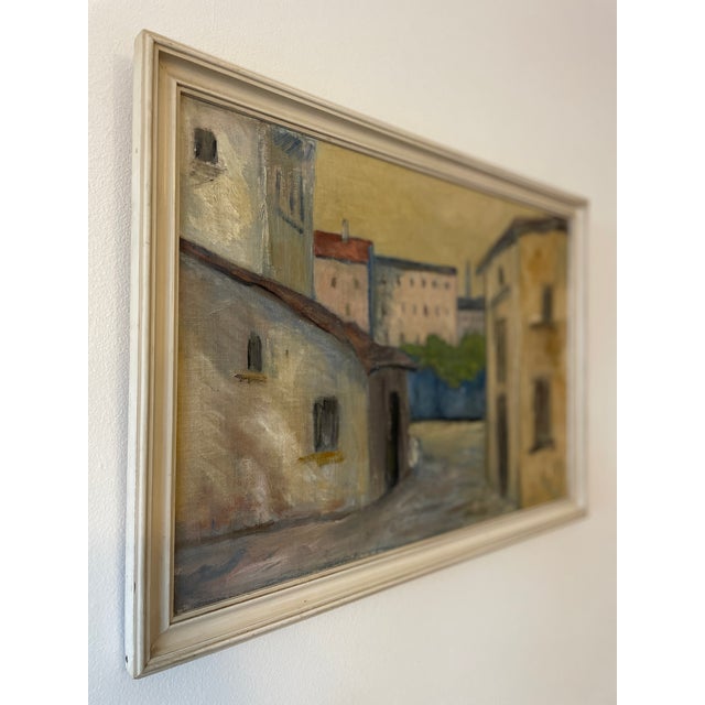This original vintage oil painting captures the understated beauty of a Mediterranean town street, with sun-washed...