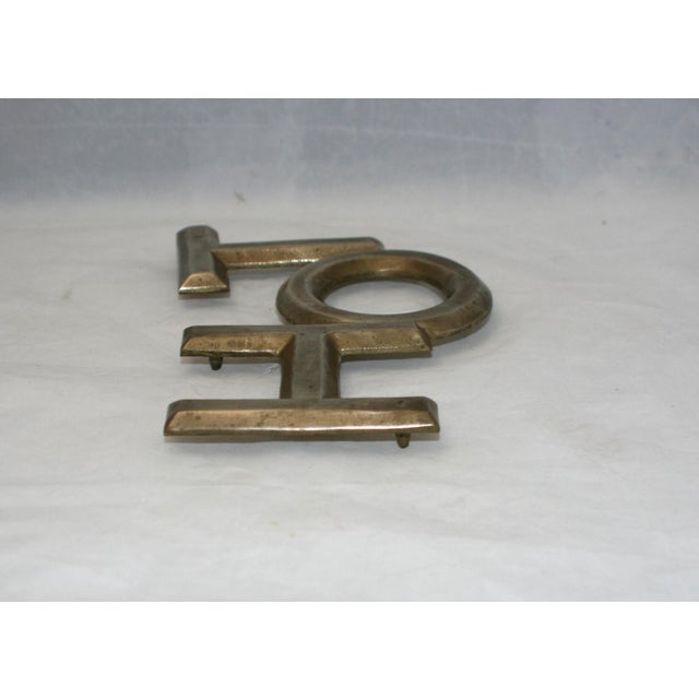 Vintage 1960s HOT Word Shaped Trivet This mid-century brass trivet was produced in Taiwan during the 1960s. The trivet...