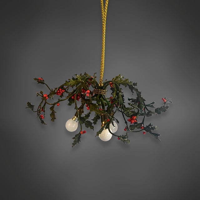 Three-light brass ceiling lamp in the shape of a holly branch. A horizontally spreading wreath of curved branches extends...