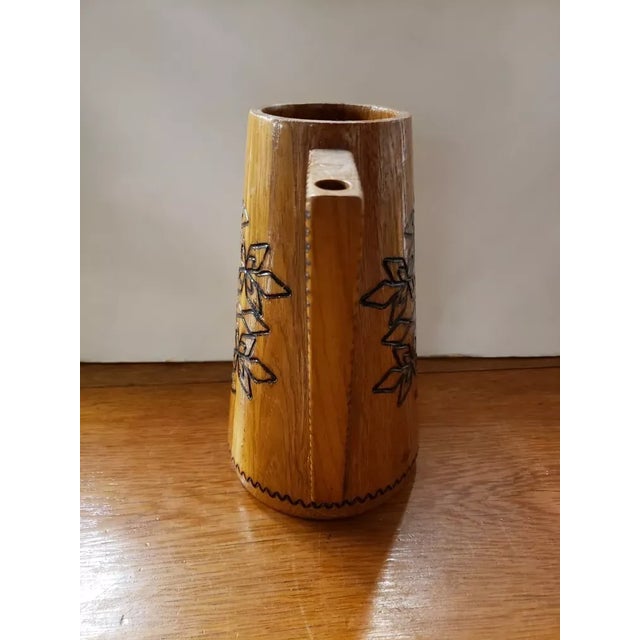 This is a Vintage Wooden Puzzle Jug Pitcher With Handles & Floral Motifs. It measures 8 1/2" high, 8 1/2“ wide and 4 3/4"...