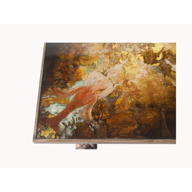 A very unusual 1960's Indonesian cocktail table with wood carved men as legs and wood frame. Reverse painted design table...