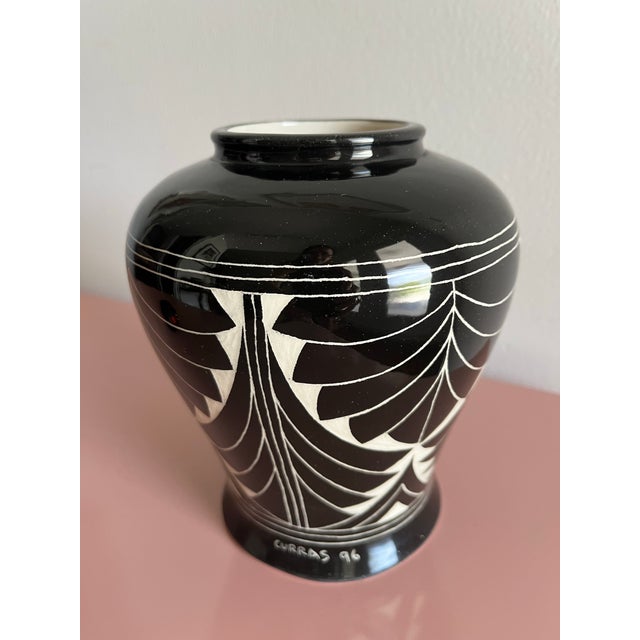 Striking black-and-white ceramic vase. Signed “Curras ’96,” Curras Brothers of Miami. The glossy black surface is...