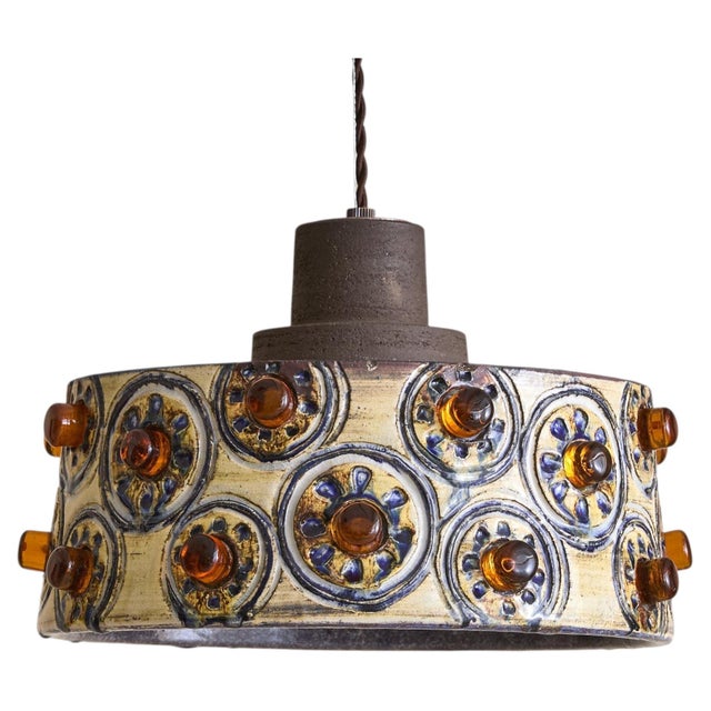 A 1960s Danish ceramic pendant by Jette Helleroe for Axella. The drum-shaped shade is wrapped in repeating medallions,...