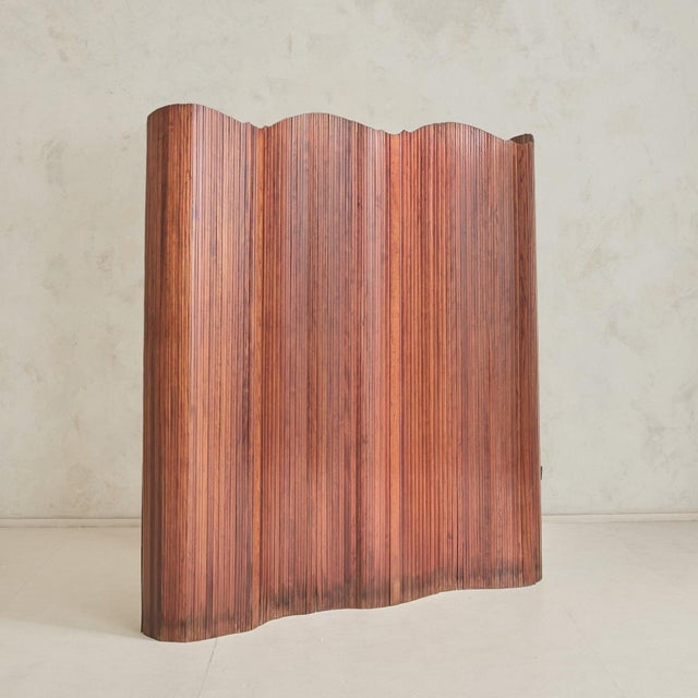 A gentle rhythm of wood and movement, this 1940s tambour room divider, attributed to French designer Jomain Baumann,...