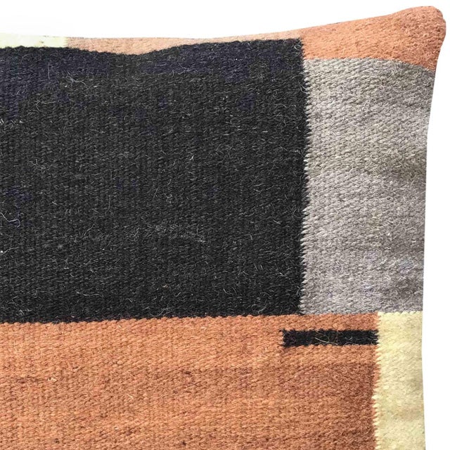 Artistic abstract geometric design handwoven wool pillow in colors of black, terra cotta, cream, and gray. Soft plush...