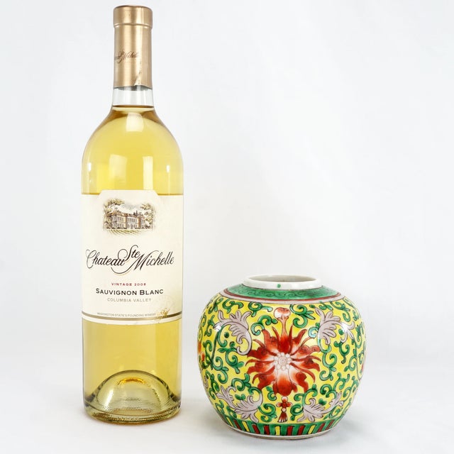 A colorful hand painted and hand potted Chinese ginger jar. The body has been hand painted in a design of lotus flowers...