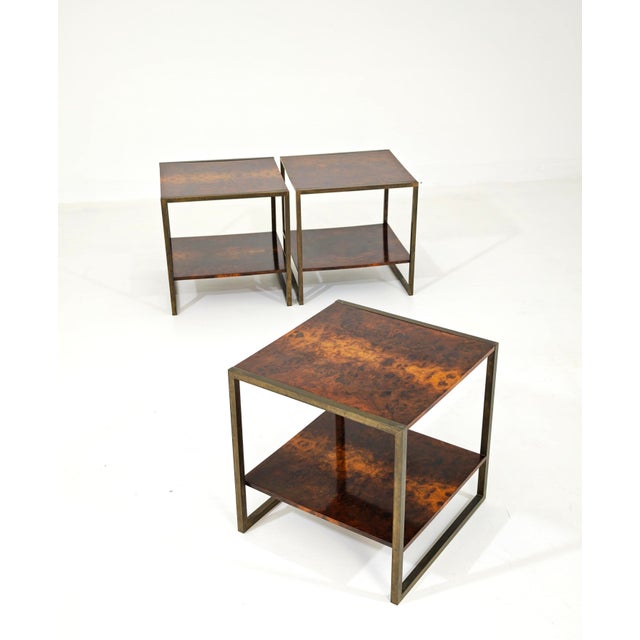 Set of three cubic coffee tables. Made in Italy, dating back to the 1970s. They feature a square brushed brass frame, with...