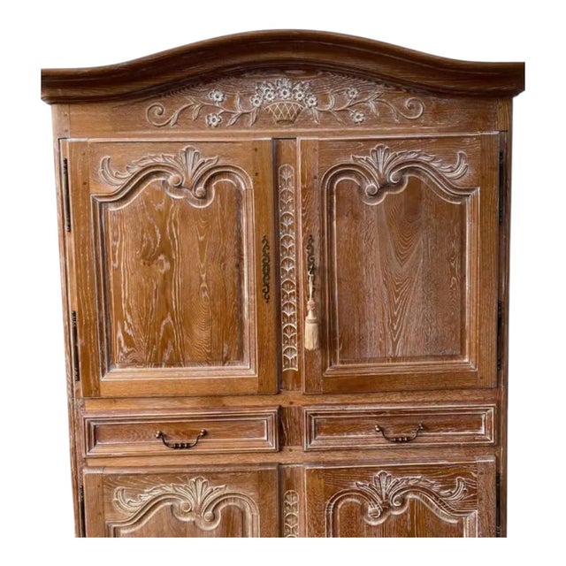 This beautiful vintage, hand-carved French Country Armoire is crafted from oak, showcasing its natural wood grain with a...