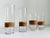 Set of four Mid-Century Modern, Carl Auböck style clear glass and rattan wrapped cocktail glasses. Includes a pair of...