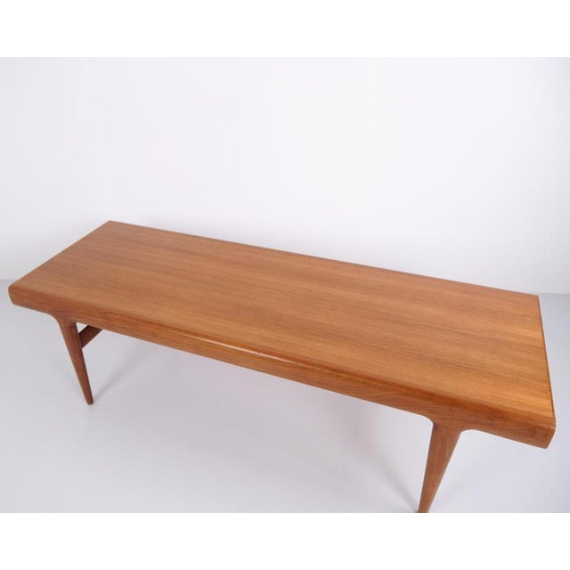 Teak coffee table designed by johannes andersen and manufactured by uldum møbelfabrik in the 1960s. The table features...
