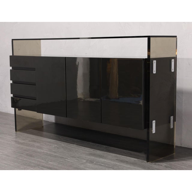 Discover an iconic design by Milo Baughman for Thayer Coggin, this meticulously restored black lacquer sideboard is the...